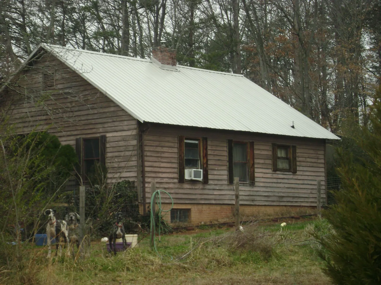 White metal roof on an old wood sided farmhouse, from a Metal Roof Installation job in Vestal